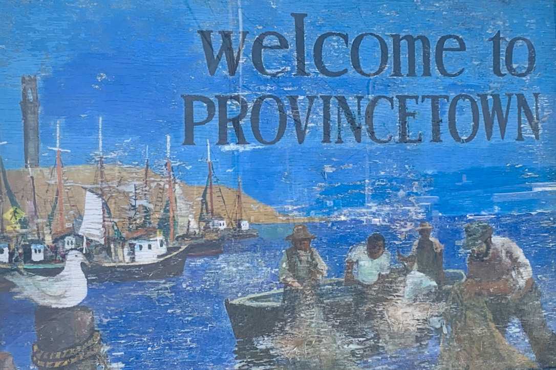 painitng on wood showing fishermen pulling in nets full of fish in Provincetown harbor (fisher boats and the Pilgrim Monument in the backgroung) and with 